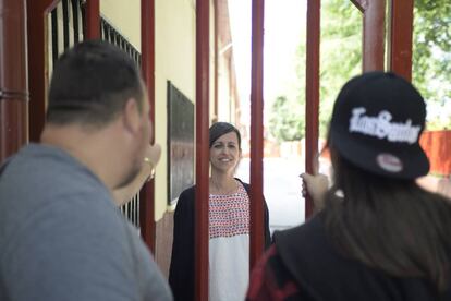 De espaldas, Adrián y María, dos menores infractores que charlan con Gema Alcañiz, su educadora.