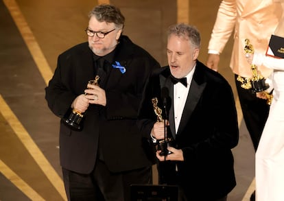 Guillermo del Toro and Mark Gustafson receive the award for best animated film for 'Pinocchio' in the first award of the evening.