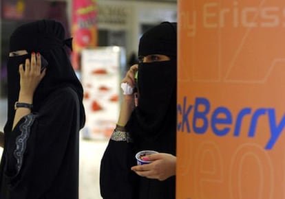 Dos mujeres hablan por teléfono en un centro comercial en Riad.