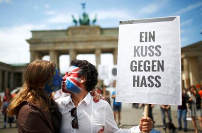 Dos activistas con las banderas europea y británica pintadas y un cartel que reza “un beso contra el odio”, en Berlín,  el 19 de junio de 2016 Berlín.
