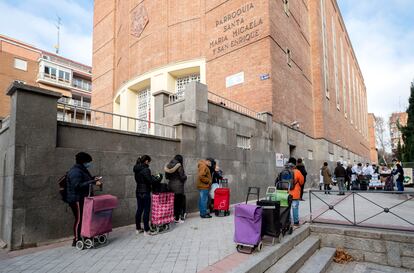 Ciudadanos esperan el reparto de alimentos ante la Fundación Madrina, en Madrid, en enero de 2021. 