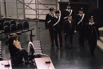 La policía escolta al mafiosos Totò Riina a su llegada a un juicio.