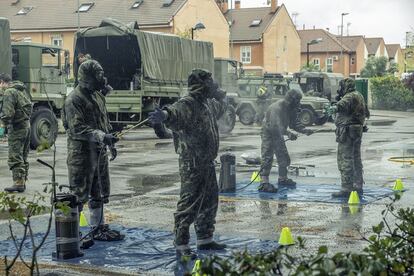 Soldiers disinfect their uniforms after entering a senior residence in Madrid.