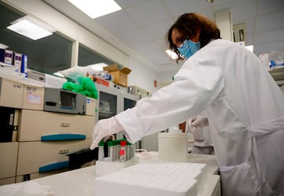 A scientist handles a PCR coronavirus tests at the microbiology laboratory of the Gregorio Maranon General Hospital in Madrid.