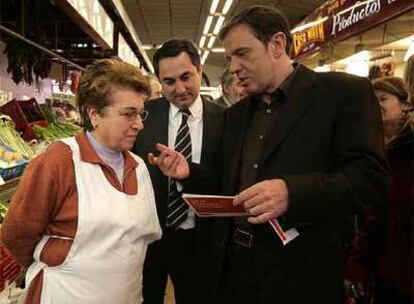 El socialista Joan Ignasi Pla, en el mercado de Castellón, ayer, con el candidato a la alcaldía, Juan M. Calles.