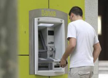 Un hombre saca dinero de un cajero automático de Bankia en Madrid. EFE/Archivo