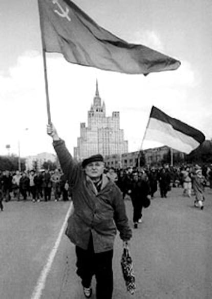 Un manifestante avanza con una bandera comunista por Moscú.