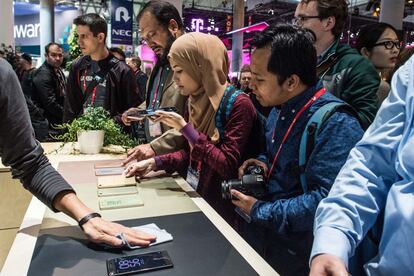 BARCELONA, SPAIN - FEBRUARY 22:  Journalists and visitors check new Sony Xperia devices on the opening day of the World Mobile Congress at the Fira Gran Via Complex on February 22, 2016 in Barcelona, Spain. The annual Mobile World Congress hosts some of the world's largest communications companies, with many unveiling their latest phones and wearables gadgets.  (Photo by David Ramos/Getty Images)