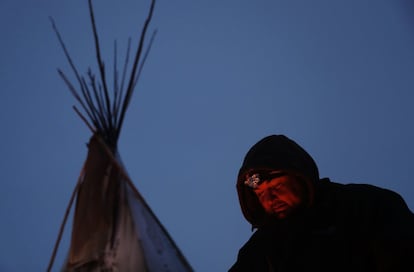 Un indígena americano se calienta junto a una fogata en el campamento cerca de la reserva sioux de Standing Rock, el 5 de diciembre de 2016.