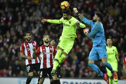 Herrerín despeja un balón ante el intento de Piqué. 