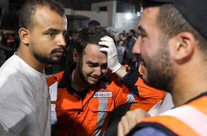 Palestinian paramedics cry outside Al Shifa hospital in Gaza, Monday, October 16.