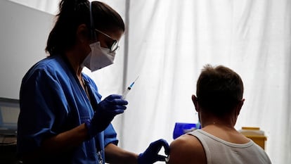 A healthcare professional administering a vaccine inside the Hotel SB Plaza Europa in Barcelona, which is being used for quarantines.