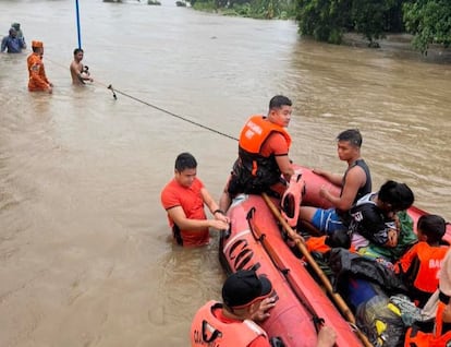A handout photo made available by the Philippine Coast Guard (PCG) shows Coastguard personnel conducting a rescue mission in the flood-hit town of Bacarra, Ilocos Norte province, Philippines, 26 July 2023.