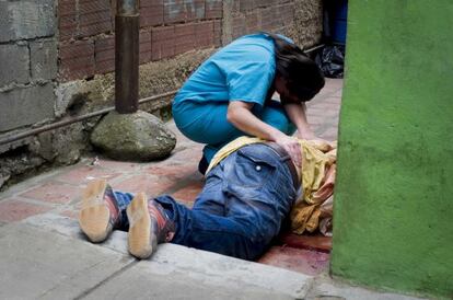 Una mujer llora en abril sobre el cadáver de su hermano, en una calle de Petarel.