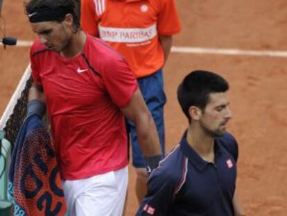 Nadal se cruza con Djokovic durante el partido.