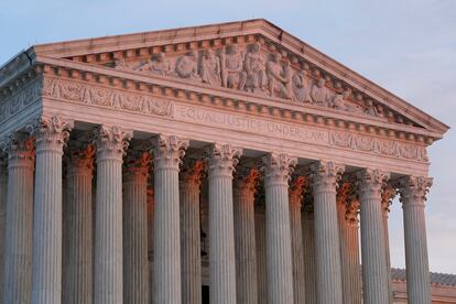 The setting sun illuminates the Supreme Court building on Capitol Hill in Washington, Jan. 10, 2023.