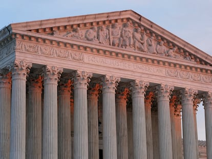 The setting sun illuminates the Supreme Court building on Capitol Hill in Washington, Jan. 10, 2023.