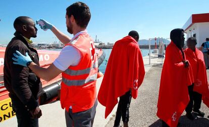 A Red Cross nurse attends to an immigrant in Algeciras.