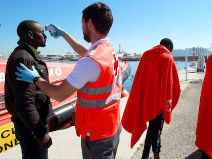 A Red Cross nurse attends to an immigrant in Algeciras.