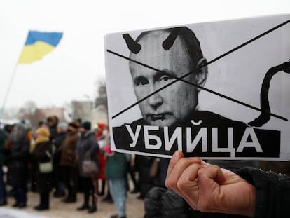 Un manifestante ucraniano sostiene una pancarta con el rostro de Vladimir Putin