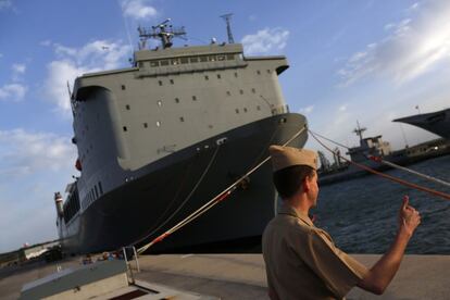 A U.S. navy personnel gestures in front of the U.S. MV Cape Ray ship docked at the naval airbase in Rota, near Cadiz, southern Spain April 10, 2014. Former container vessel Cape Ray, docked in southern Spain, has been fitted out with at least $10 million of gear to let it take on about 560 metric tonnes of Syria's most dangerous chemical agents and sail them out to sea, said officials. Experts on board a cargo ship transformed into a multi-million dollar chemical weapons destroyer said on Thursday they were ready to start working on Syria's stock of toxic arms in the middle of the Mediterranean as early as May. Now they just have to hope the weather holds and Damascus delivers on time. REUTERS/Marcelo del Pozo (SPAIN - Tags: MILITARY MARITIME POLITICS CIVIL UNREST CONFLICT) - RTR3KSCY