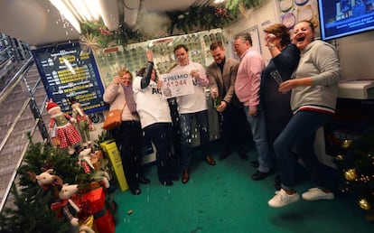 A lottery shop celebrates having sold the second-prize winning number