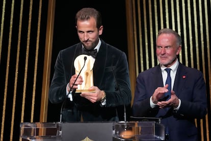 England and Bayern Munich player Harry Kane receives the Gerd Müller Trophy from Karl-Heinz Rummenigge, an award that goes to Real Madrid's Kylian Mbappe, who was not present at the ceremony.