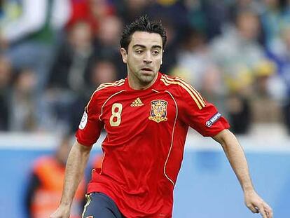 Xavi conduce el balón en el partido contra Suecia.