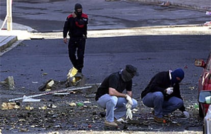 La Ertzaintza recoge restos del vehículo en el que viajaban los presuntos terroristas.