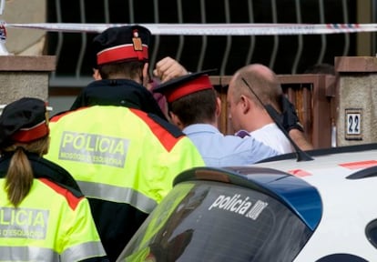 Agentes de los Mossos d' Esquadra conducen esta mañana al presunto autor del crimen Daniel Pierre, de 40 años, a la vivienda donde se encontró a una mujer muerta en Sant Pere Pescador.