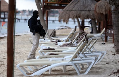 Members of the National Guard stand guard at an exclusive hotel in Quintana Roo where two people were killed in reception.