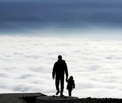 Un hombre junto a un niño camina hacia la cima de la montaña Vodno en Skopje, Macedonia.