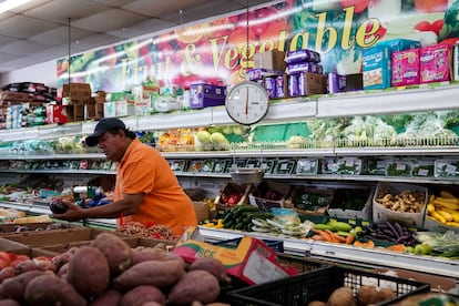 A man shops for vegetables at a Best World supermarket in Washington, D.C., in August 2022.