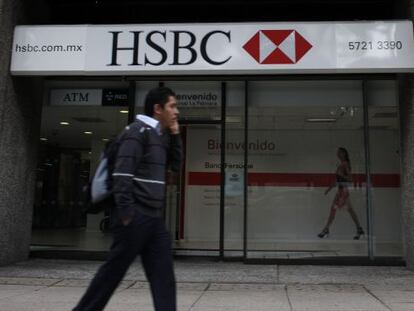 A man walks past a branch of British bank HSBC in Mexico City.