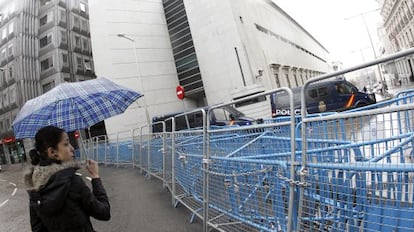 A woman looks at the barriers set up in front of Congress last February to prevent protestors from getting near the building.