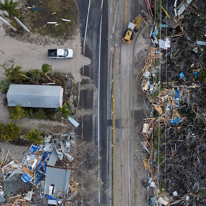 A drone view shows a bulldozer removing debris from a road after Hurricane Milton made landfall in Matlacha, Florida, U.S., October 10, 2024. REUTERS/Ricardo Arduengo