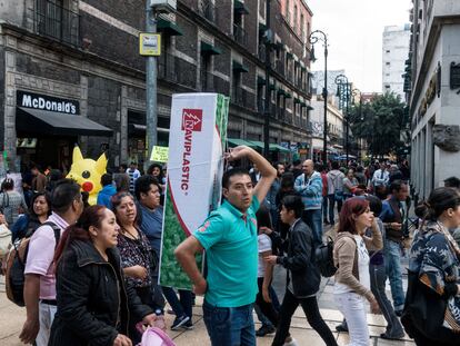 Un hombre carga un árbol de Navidad por una de las calles del centro de Ciudad de México.