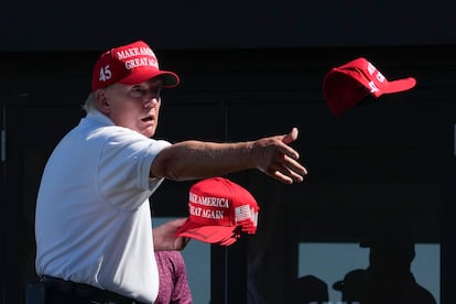 Former President Donald Trump throws autographed caps to the crowd during the final round of the Bedminster Invitational LIV Golf tournament in Bedminster, N.J., on Aug. 13, 2023.