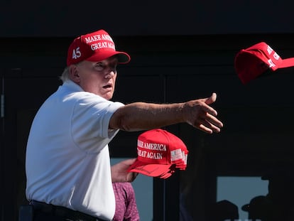 Former President Donald Trump throws autographed caps to the crowd during the final round of the Bedminster Invitational LIV Golf tournament in Bedminster, N.J., on Aug. 13, 2023.