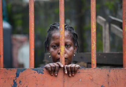 Una residente del West Point, un suburbio de Monrovia (Liberia), detrás de una de las vallas que cierra el barrio por la cuarentena ante el ébola.