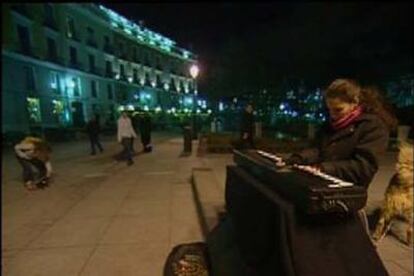 Edith Peña toca el teclado portátil en la plaza de Oriente de Madrid.