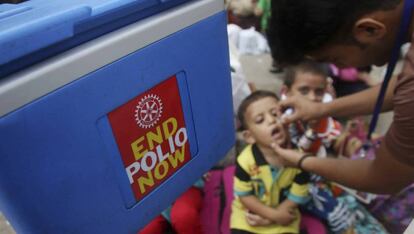 Un trabajador sanitario administra la vacuna de la polio a un niño, durante la campaña realizada en Karachi (Pakistán).
