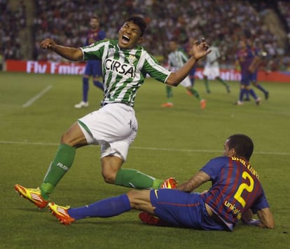 Dani Alves floors Jefferson Montero in a match against Betis. 