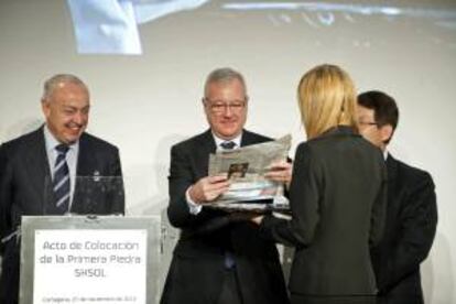 El presidente de la comunidad autónoma de Murcia, Ramón Luis Valcárcel (c) se dispone a introducir los periódicos del día en una urna durante el acto oficial de colocación de la primera piedra de la  nueva planta de lubricantes de última generación que pondrá en marcha Repsol con la empresa coreana SKL, en el Valle de Escombreras.