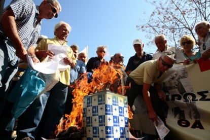 Un grupo de pensionistas quema la documentación que les ha enviado el Ministerio de Finanzas sobre las nuevas cargas fiscales en protesta por las medidas del Gobierno.
