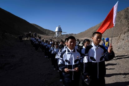 Los primeros en visitar la base han sido un grupo de adolescentes que han podido explorar grutas en un desierto que recuerda al del planeta Marte. En la imagen, los estudiantes pasan junto a un modelo de aterrizaje de la 'Base Marte 1'.