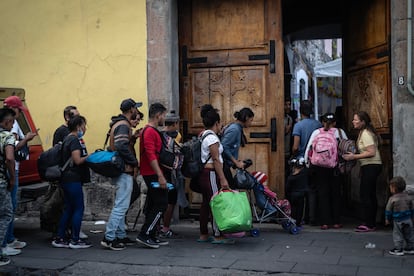 Groups of migrants enter the parish church, on October 27, 2023.