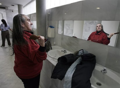 Una mujer se acicala tras ducharse en la Casa de Baños Públicos de Embajadores.