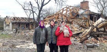 From left, friends Nina Vasilenka, Valentina and Natalia, at an intersection in Sukachi that was hit by a missile.