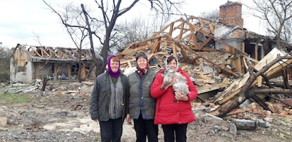 From left, friends Nina Vasilenka, Valentina and Natalia, at an intersection in Sukachi that was hit by a missile.